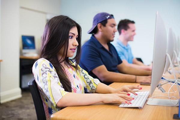 Close up of student attentively listening to her professor during class